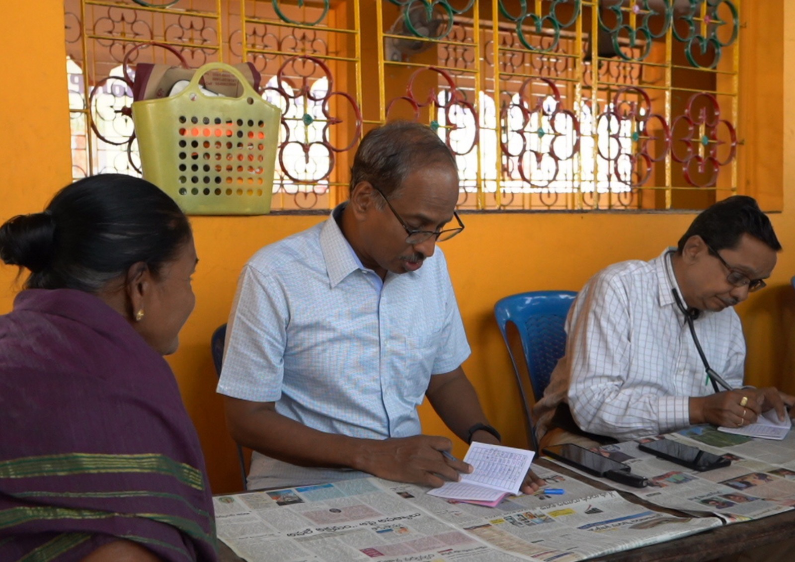 A smiling senior man looking out a window.