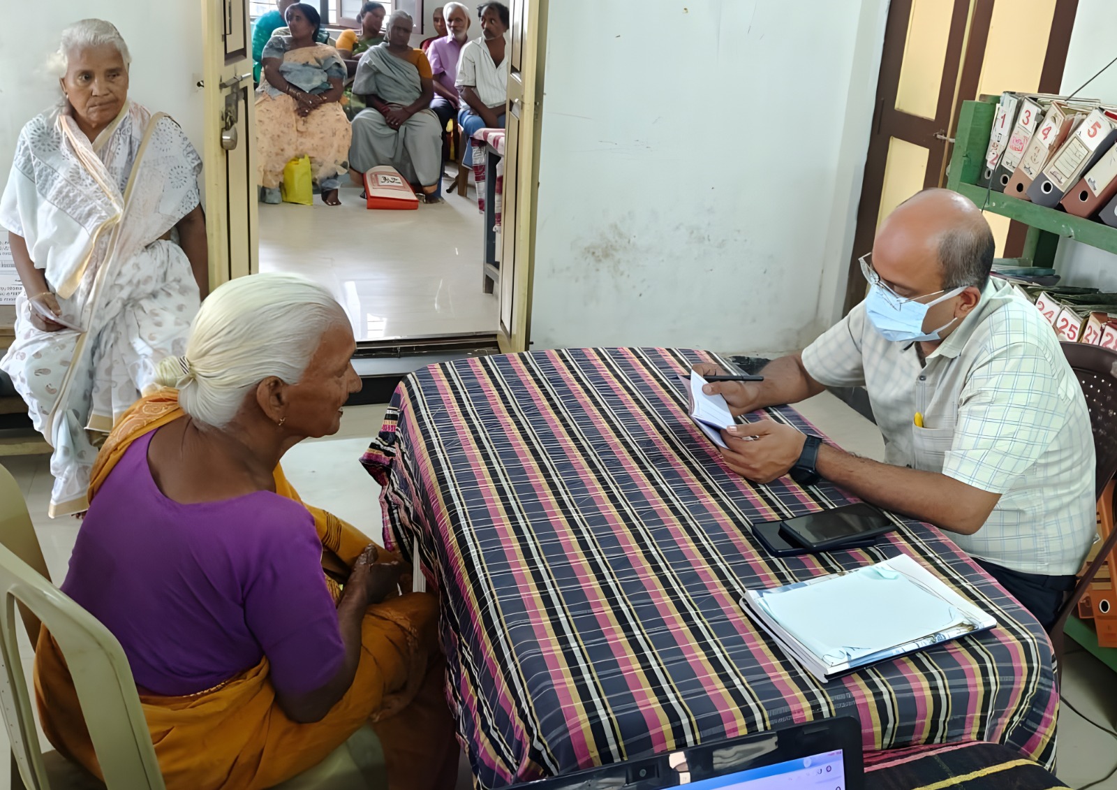 A doctor conducting a health check-up at a community center.